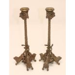 A PAIR OF BRONZE GRAND TOUR TYPE CANDLESTICKS, c.1900, the turned sconces with goat mask and