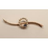 A SEED PEARL AND SAPPHIRE BAR BROOCH, the "S" scroll knife edge bar centred by a small circlet of