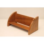 A ROBERT THOMPSON ADZED OAK BOOK TROUGH of oblong form with crescent shaped ends on bracket feet,