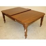 A VICTORIAN MAHOGANY DINING TABLE of rounded oblong form with pull out action and a separate leaf,