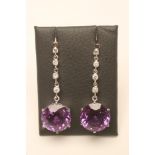 A PAIR OF AMETHYST AND DIAMOND DROP EAR STUDS, the facet cut circular amethyst claw set to a 2.5cm