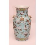 A CHINESE PORCELAIN VASE of rounded cylindrical form, the sloping shoulders applied with four dog of