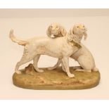 A ROYAL DUX BISQUE PORCELAIN MODEL, early 20th century, as a pair of setters, one seated, the