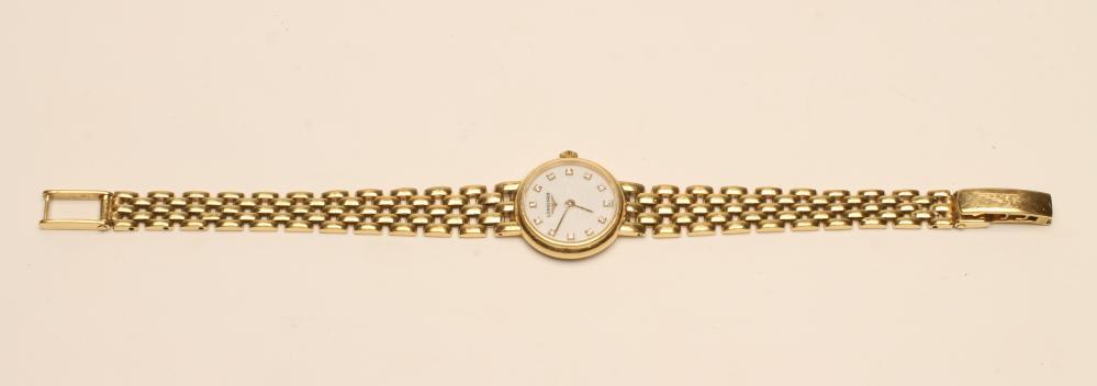 A LADY'S LONGINES 18CT GOLD WRISTWATCH, the circular white dial inset with diamond "dot" markers