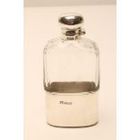 AN EDWARDIAN SILVER HIP FLASK, makers F C Austin & Co., Sheffield 1906, the clear glass flask with