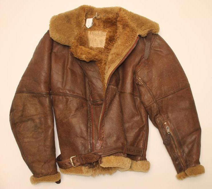 A SECOND WORLD WAR LEATHER FLYING JACKET, with sheepskin lining, waist strap and interior label,