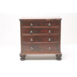 A WILLIAM IV MAHOGANY MINIATURE CHEST, the banded top over four graduated cockbeaded drawers with
