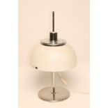 A HARVEY GUZZINI CHROME TABLE LAMP, 1970's, the domed white plastic adjustable shade on plain turned