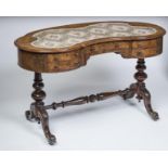 A LADY'S VICTORIAN WALNUT PILLAR END DESK of kidney form, the moulded edged top with inset writing