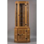 A ROBERT THOMPSON ADZED OAK STANDING CORNER CUPBOARD of canted two stage form, half penny moulded