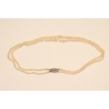 A DOUBLE STRAND CULTURED PEARL NECKLACE, the graduated pearls set to a 9ct white gold clasp