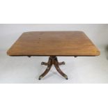 A MAHOGANY BREAKFAST TABLE, early 19th century and later, the banded rounded oblong tip up top