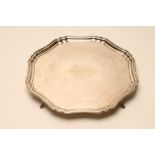 A SILVER SALVER, maker's mark J.S., Sheffield 1931, of rounded octagonal form with pie crust rim,