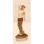 AN ART DECO ROYAL DUX BISQUE PORCELAIN FIGURE modelled as a semi nude young maiden wearing an