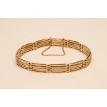 A GOLD BRACELET, with ten slightly convex straight five bar panels, clasp stamped 15ct, with