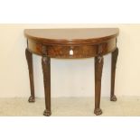 A MAHOGANY PIER TABLE, early 20th century, of demi lune form with folding top, plain ribbon edged