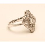 AN ART DECO STYLE DIAMOND RING, the central brilliant cut stone open back collet set to an open