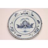 AN ENGLISH DELFT CHARGER, late 18th century, of plain dished circular form, centrally painted in