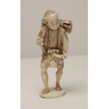 A JAPANESE IVORY OKIMONO, Meiji period, carved as a woodman wearing sandals and carrying a bundle of