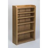 A ROBERT THOMPSON OAK OPEN BOOKCASE of oblong form with galleried surmount and adjustable