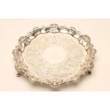 A GEORGE III SMALL SILVER SALVER, maker possibly Henry Chawner, London 1787, of shaped circular form