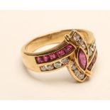 A RUBY AND DIAMOND COCKTAIL RING, the central marquise cut ruby within open borders channel set with