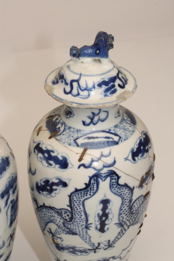 A PAIR OF CHINESE PORCELAIN VASES AND COVERS, of inverted baluster form, painted in underglaze - Image 2 of 5