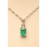 AN EMERALD PENDANT, the Princess cut Colombian stone of approximately 2cts claw set to two graduated