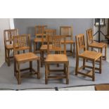A SET OF EIGHT ROBERT THOMPSON OAK DINING CHAIRS, the tapering back with straight top rail over
