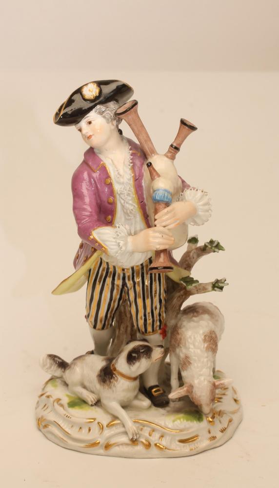 A MEISSEN PORCELAIN FIGURE, late 19th century, modelled as a young man wearing a be-ribboned black
