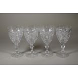 A SET OF FOUR LATE VICTORIAN "BRILLIANT CUT" GLASS GOBLETS, the plain "U" shaped bowls with fan,