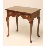 A GEORGIAN STYLE MAHOGANY DRESSING TABLE, the moulded edged and banded top over scrolled frieze with