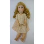 A Gebruder Heubach bisque head character doll with brown glass sleeping eyes, open mouth and