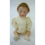 A German bisque head character boy doll with brown glass sleeping eyes, closed mouth, brown mohair