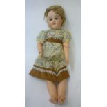 A Max Handwerck bisque head doll with sleeping brown glass eyes, open mouth and teeth, auburn mohair