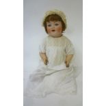 A Kammer & Reinhardt bisque head character doll with blue glass sleeping eyes, open mouth and teeth,