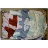 A quantity of dolls clothing including a christening gown, in cotton, wool and silk (Est. plus 18%