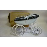 A Silver Cross coach built baby carriage, 1990's, with lined cream body, navy canvas hood and cover,