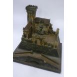 A painted wood castle dismantling into sections on base, 21" x 18", a similar plastic castle and a