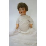 An Armand Marseille bisque head character doll with blue glass sleeping eyes, open mouth and