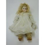 A Belton bisque shoulder head doll with fixed blue glass eyes, closed mouth, blonde mohair wig,