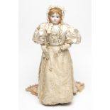 A Madame Barrois bisque shoulder head doll with fixed blue glass eyes, closed mouth, light brown