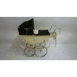 A Silver Cross coach built toy baby carriage, late 1950's/early 1960's with lined cream body,