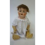 A Kammer & Reinhardt bisque head character doll with blue glass flirty eyes, open mouth, brown