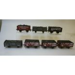 Seven coal trucks, two of wood construction and five P.O. lettered wagons, all with coal load, E (