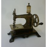 A German toy hand sewing machine, early 20th century, by Gebrauchs-Anweisung, with japanned metal