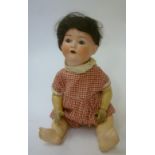 An Ernst Heubach bisque head doll with blue glass sleeping eyes and open mouth, black mohair wig,