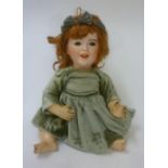 A French S.F.B.J. bisque head character doll with brown glass sleeping eyes, closed mouth, auburn