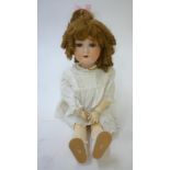 An Armand Marseille bisque head doll with blue glass sleeping eyes, open mouth and teeth, later