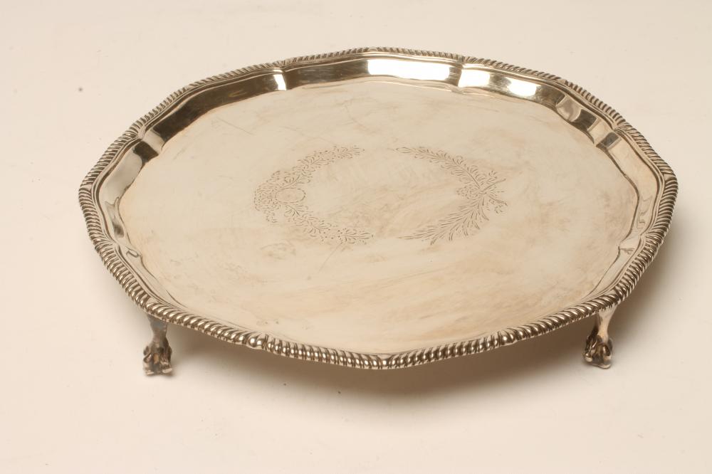 A VICTORIAN SILVER WAITER, makers Bradbury & Henderson, London 1883, of shaped circular form with